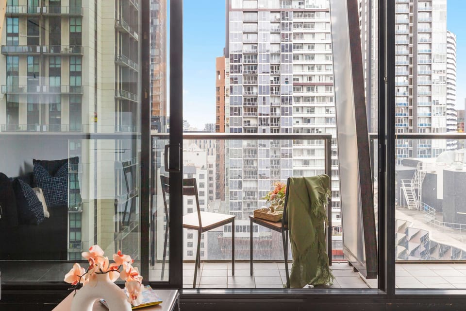 A balcony with city views. *(Chairs on balcony are from the dining area).