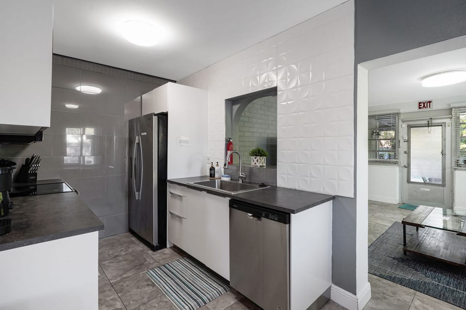 Cook with ease in a fully equipped kitchen featuring modern appliances, cookware, and plenty of counter space for meals at home.
