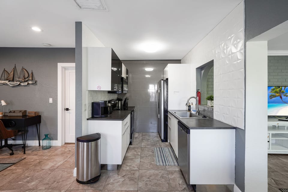 Cook with ease in a fully equipped kitchen featuring modern appliances, cookware, and plenty of counter space for meals at home.