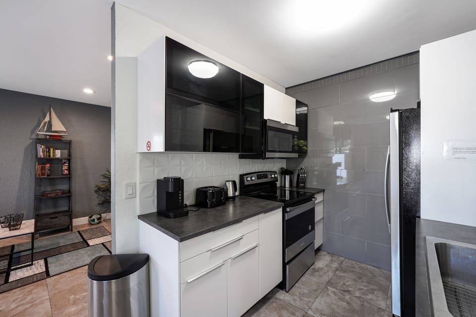 Cook with ease in a fully equipped kitchen featuring modern appliances, cookware, and plenty of counter space for meals at home.