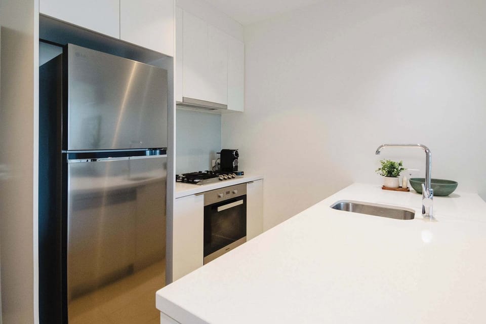 Kitchen with Nespresso coffee machine, dishwasher and large kitchen bench