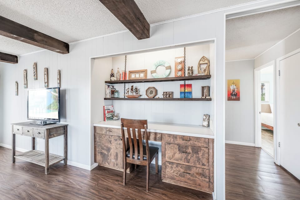 Your built-in desk nook with floating shelves creates the perfect workspace for planning adventures or catching up on emails.