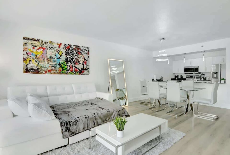 Modern and well decorated living space with a cozy pull out sofa bed. Large glass sliding door revealing the gorgeous city and abundance of natural light.