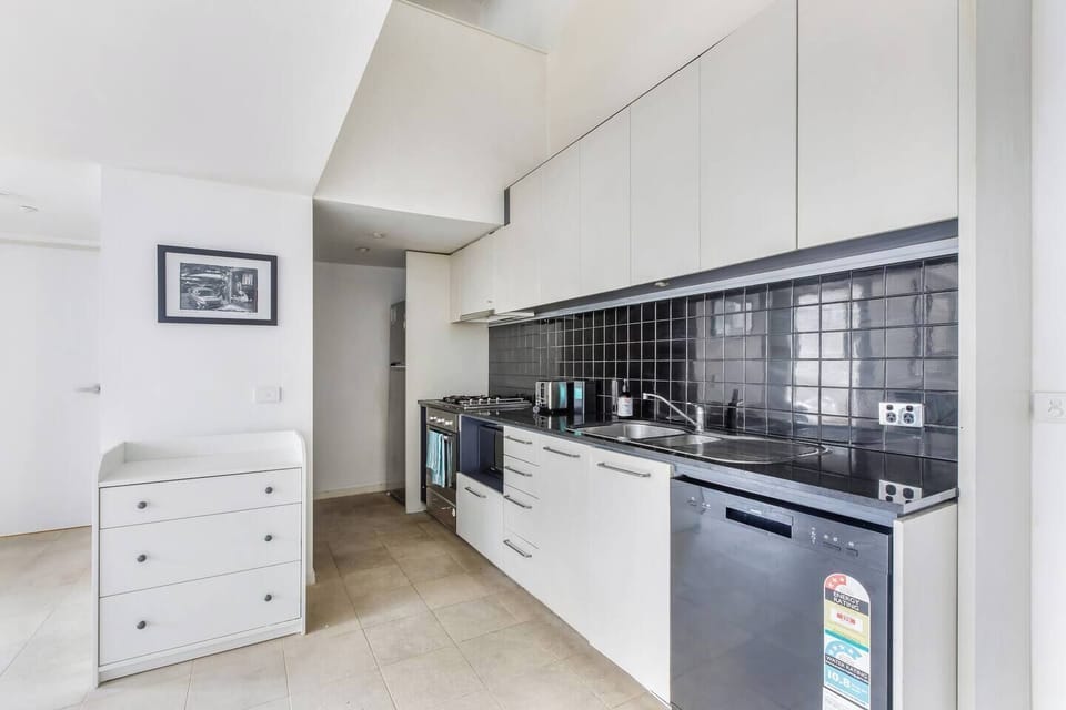 Cook up simple meals in the compact yet efficient kitchen featuring a gas stove, oven, dishwasher, and a French press for your morning coffee.