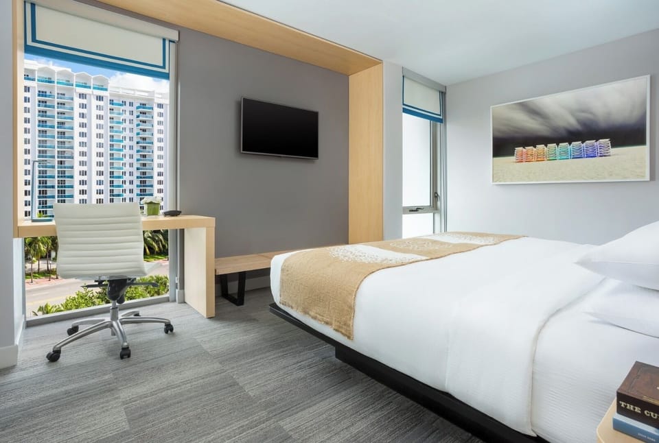 Recharge after meetings with a sleek workspace and comfy bed.