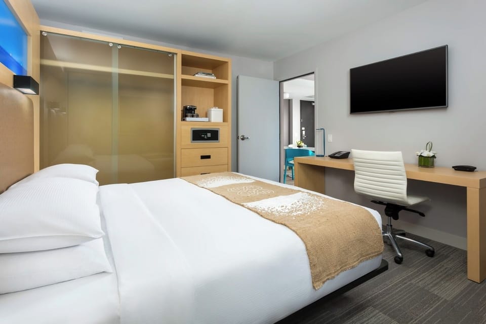 Unwind in crisp linens with a dedicated work desk.