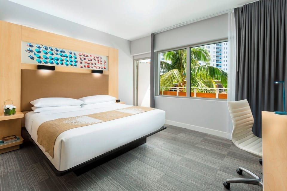 Unwind in a sunlit bedroom with calming palm views.