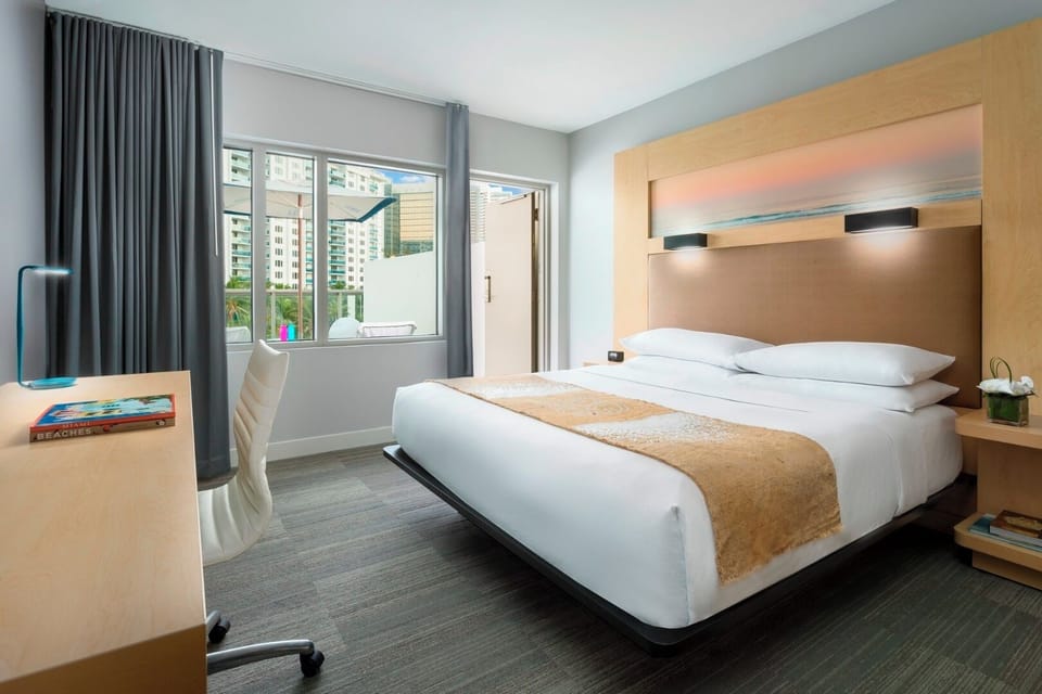 Settle into a serene bedroom with workspace and soft lighting.