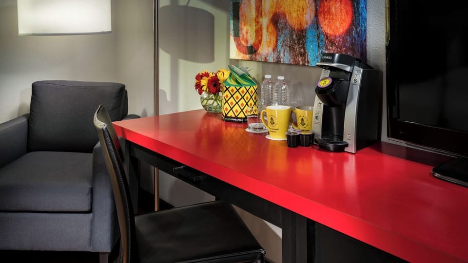 Settle in with a cozy chair, bright desk, and coffee station