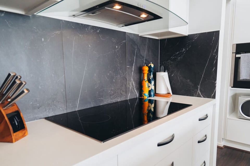Cook with ease in the fully equipped kitchen, featuring an electric stove, kettle, coffee maker, and a full set of knives.