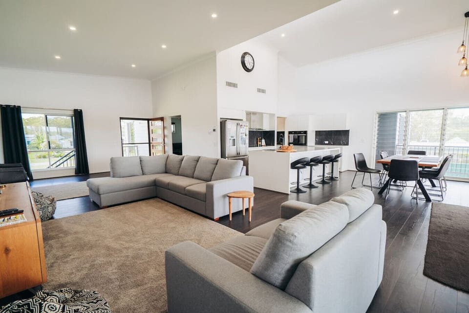 Unwind in the open living area with a large, comfortable sofa, Smart TV, and side chairs – ideal for movie nights or quiet afternoons.