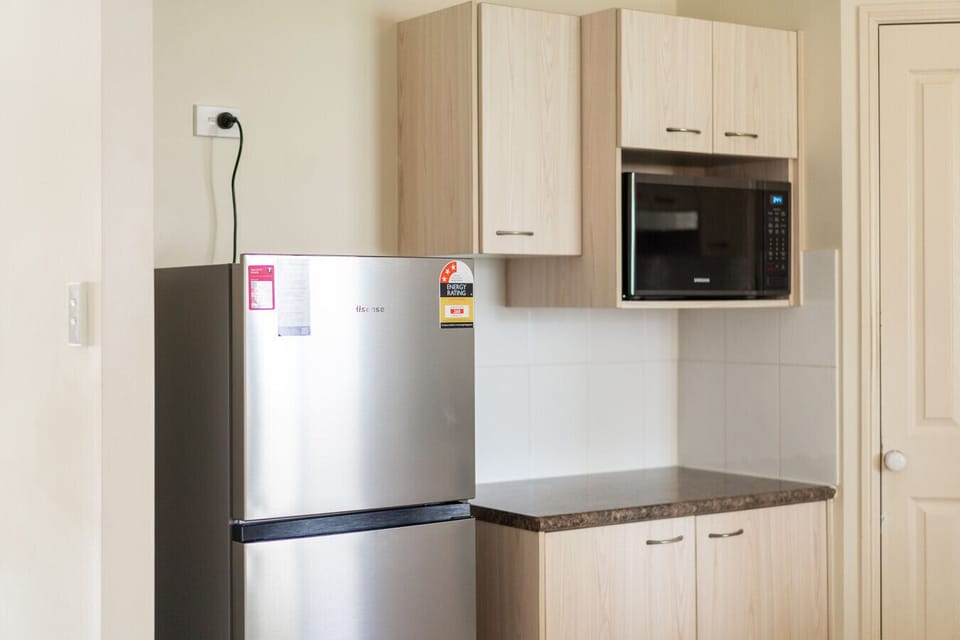 Fully Equipped Kitchen Cook with ease using the stove, oven, fridge, microwave, and kettle.