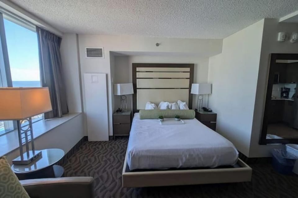 Well-Lit Bedroom Featuring a Comfortable Queen-Sized Bed!