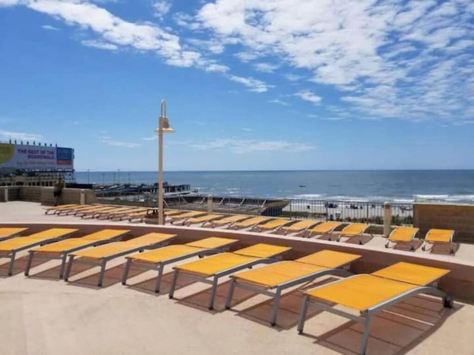 Enjoy the Shared Pool Deck with Comfortable Loungers!