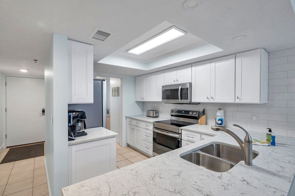 Modern kitchen w/ sleek cabinetry & generous counter space for easy meal prep.