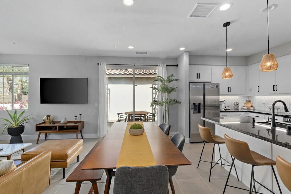 Dining table w/ seating for a group, set beside the kitchen for easy meals