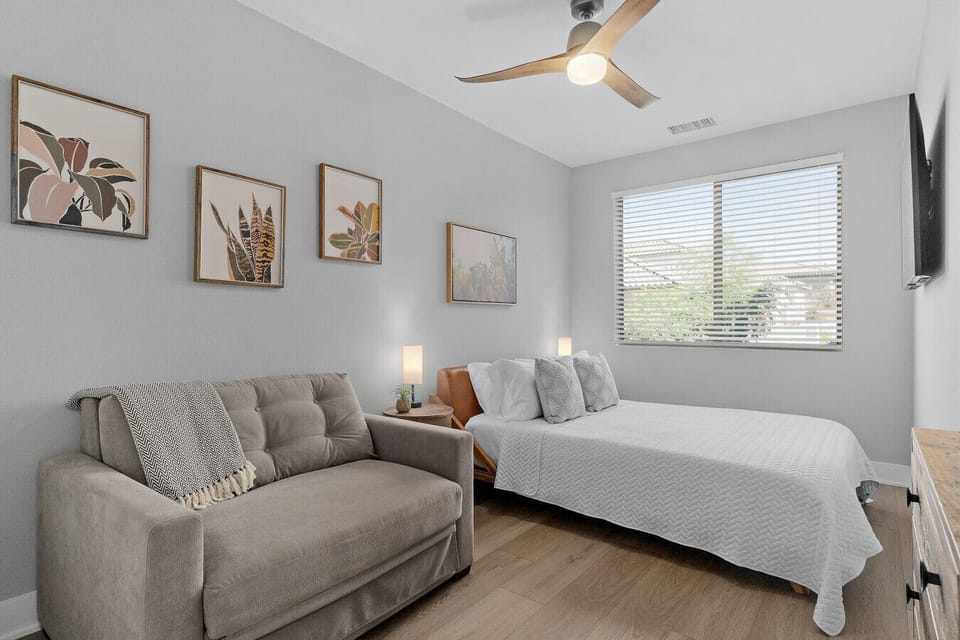 Flexible bedroom w/ bed & sofa seating, ideal for relaxing or extra guests