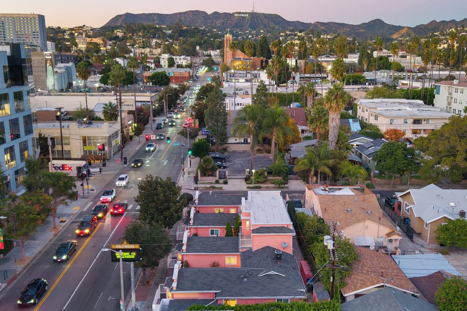 Aerial view of this charming pink retreat, nestled in a palm-lined neighborhood close to the city buzz.