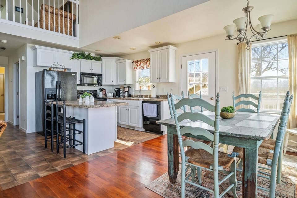 Start your mornings with coffee and panoramic lake views from this beautifully designed kitchen and dining area. Serenity and style meet here! "Lake House"