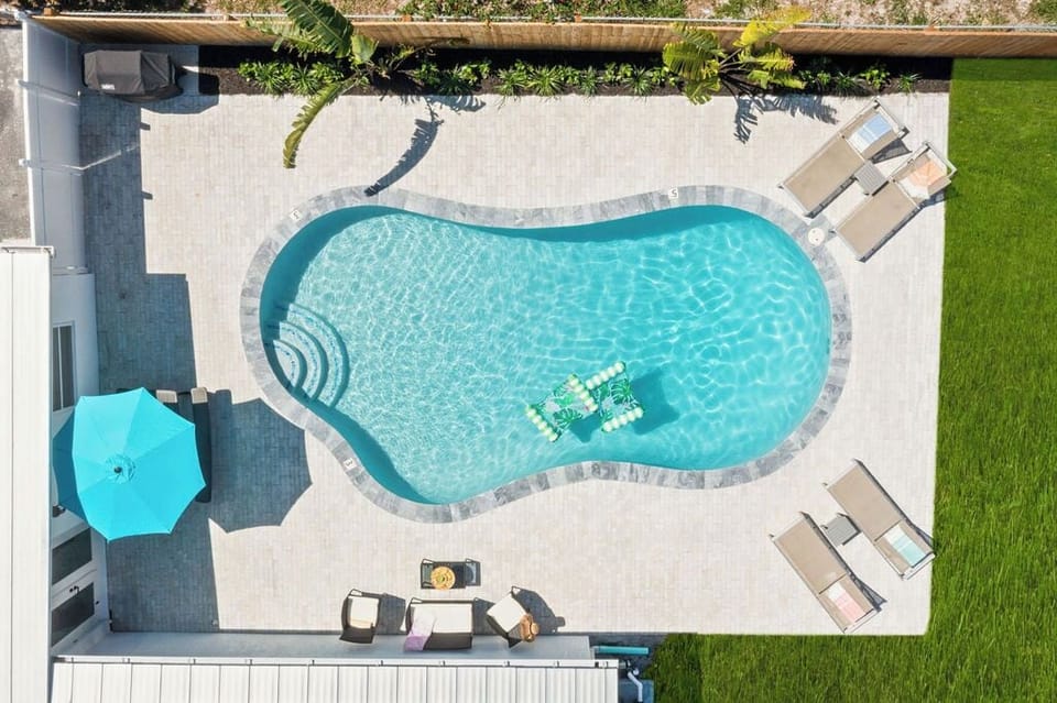 An Aerial view of the outdoors and its sparking pool. What a Paradise!