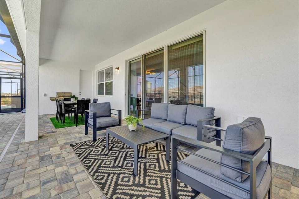 Relax on this stylish patio with comfy seating and a dining area, perfect for outdoor gatherings.