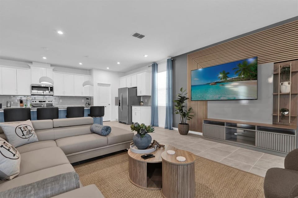 Relax in this modern living room with a sleek open kitchen, perfect for entertaining and unwinding.