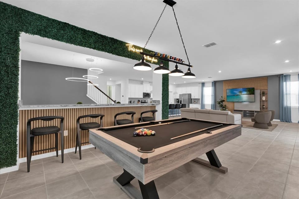 Enjoy a game night in this stylish entertainment space with a sleek pool table and modern amenities.