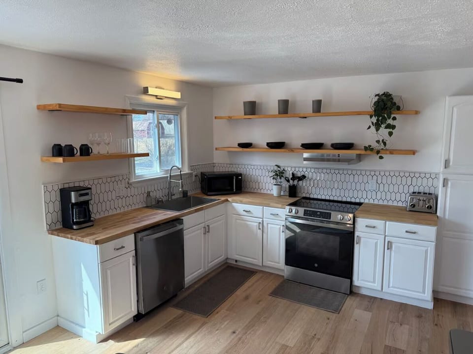 Open concept kitchen with fully appointed appliances and utensils 