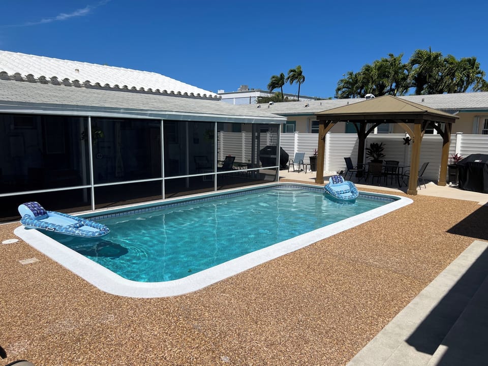 Pool, patio gazebo grill showing your private screened in patio