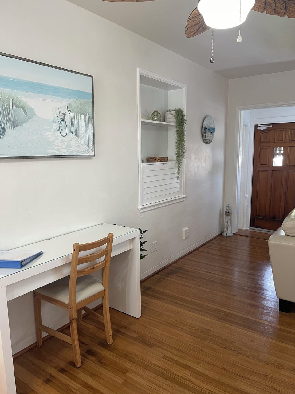 desk and chair with front door.