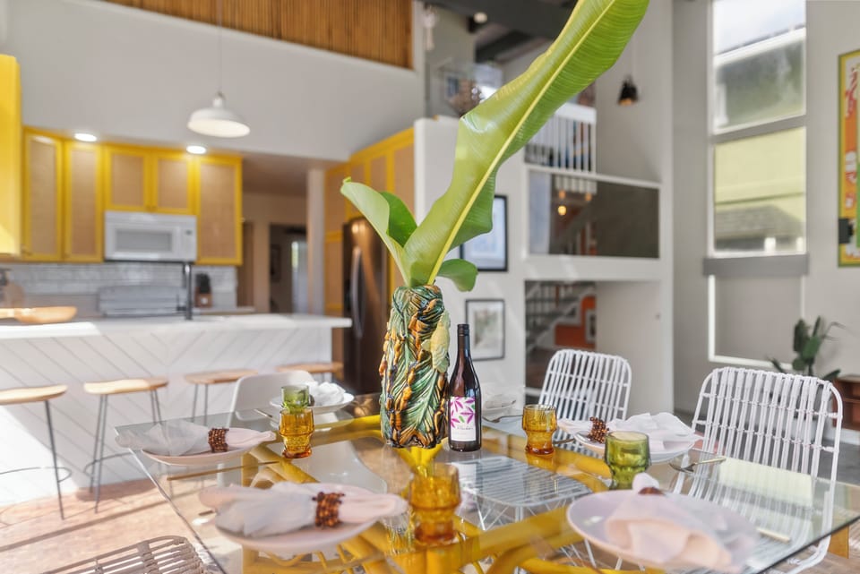 Gather around the dining table for a meal with family, surrounded by warm tropical decor.