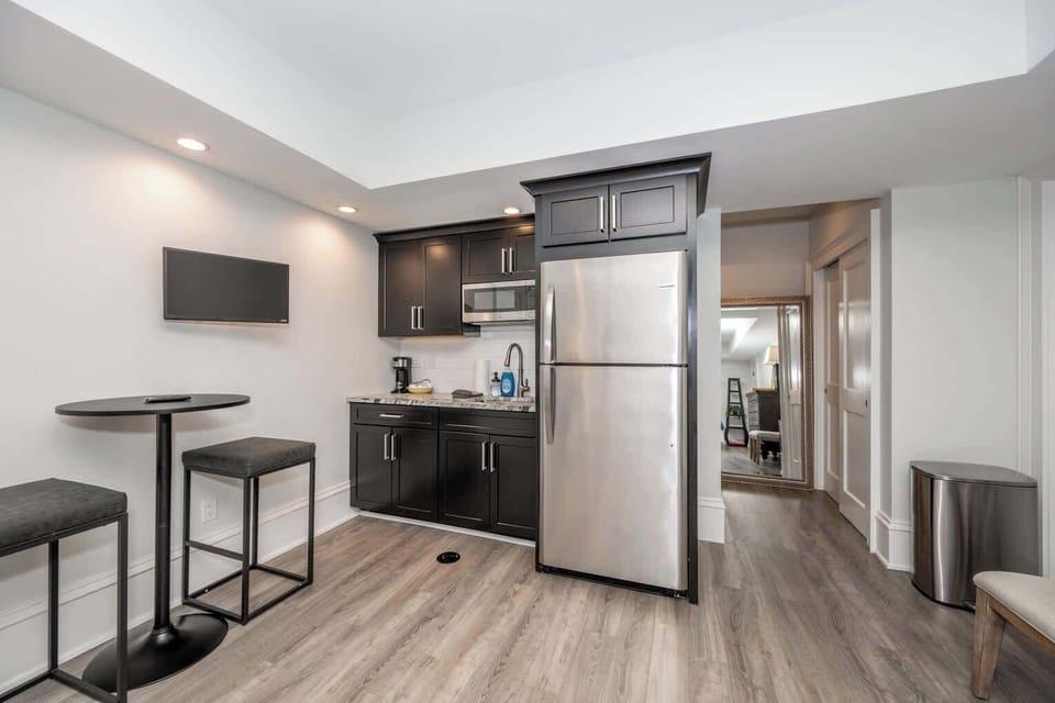 This chic studio features a plush king bed, smart TV, kitchenette, & full bath