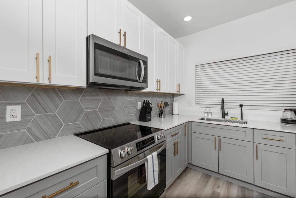 Functional kitchen with oven, stove, fridge and basic cooking ware