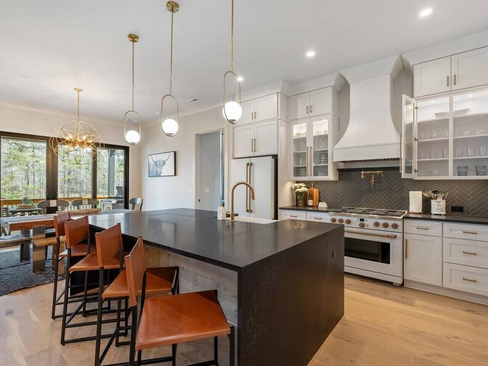 Gourmet space with sleek high-end appliances and a stylish island perfect for culinary adventures!