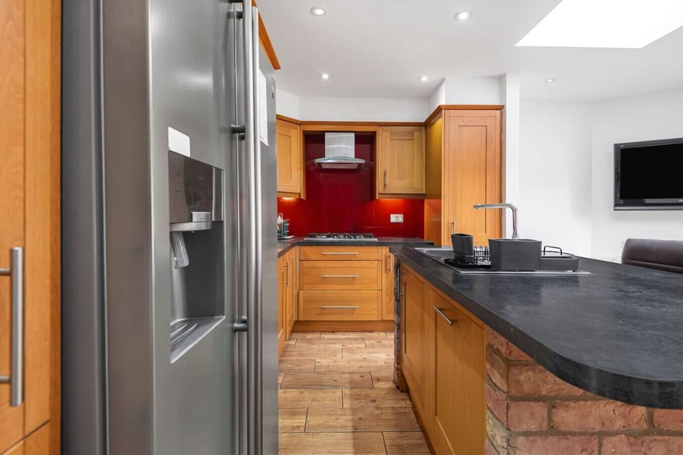 Spacious kitchen with sleek counters and appliances