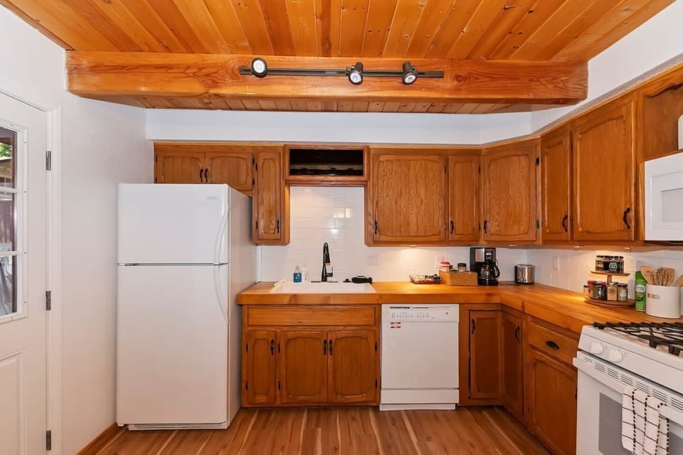 The kitchen in the cabin comes with all of the necessary supplies to make a delicious meal.