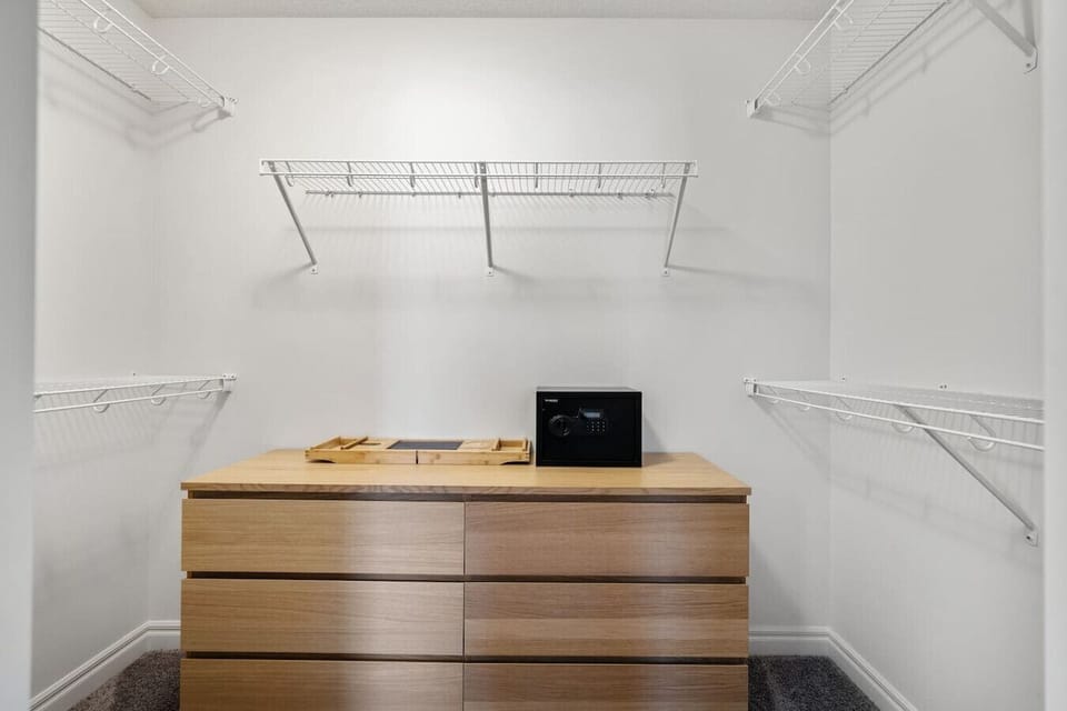 Primary bedroom (located upstairs) with a king bed, Smart TV, closet, room-darkening shades & a private 5-piece ensuite bathroom.