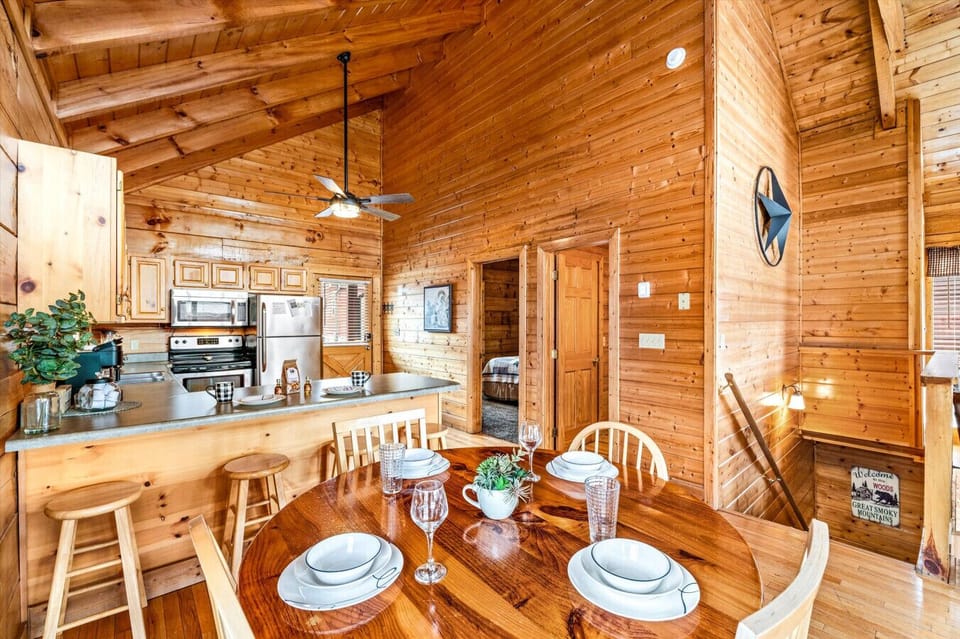 Gather around the beautifully set dining table with seating for four and additional island seating for four!
