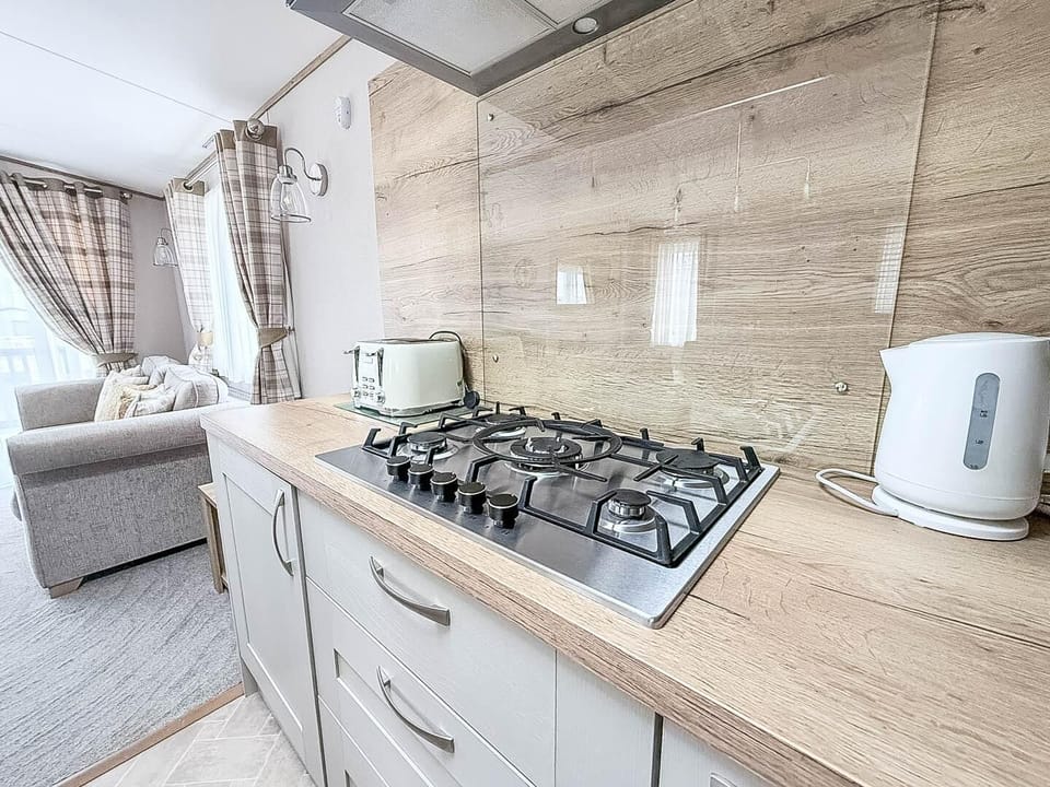Situated conveniently opposite the kitchen, this dining table is the ideal spot for sharing meals, playing board games, or simply planning your next day's adventure on the Norfolk coast.
