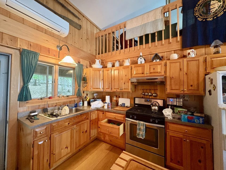 Rustic-style kitchen equipped with modern appliances and all essentials to prepare meals