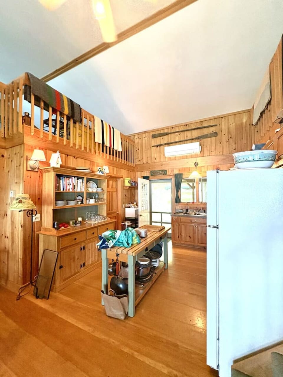 Inviting loft-style layout with warm wooden interiors, perfect for relaxing or reading