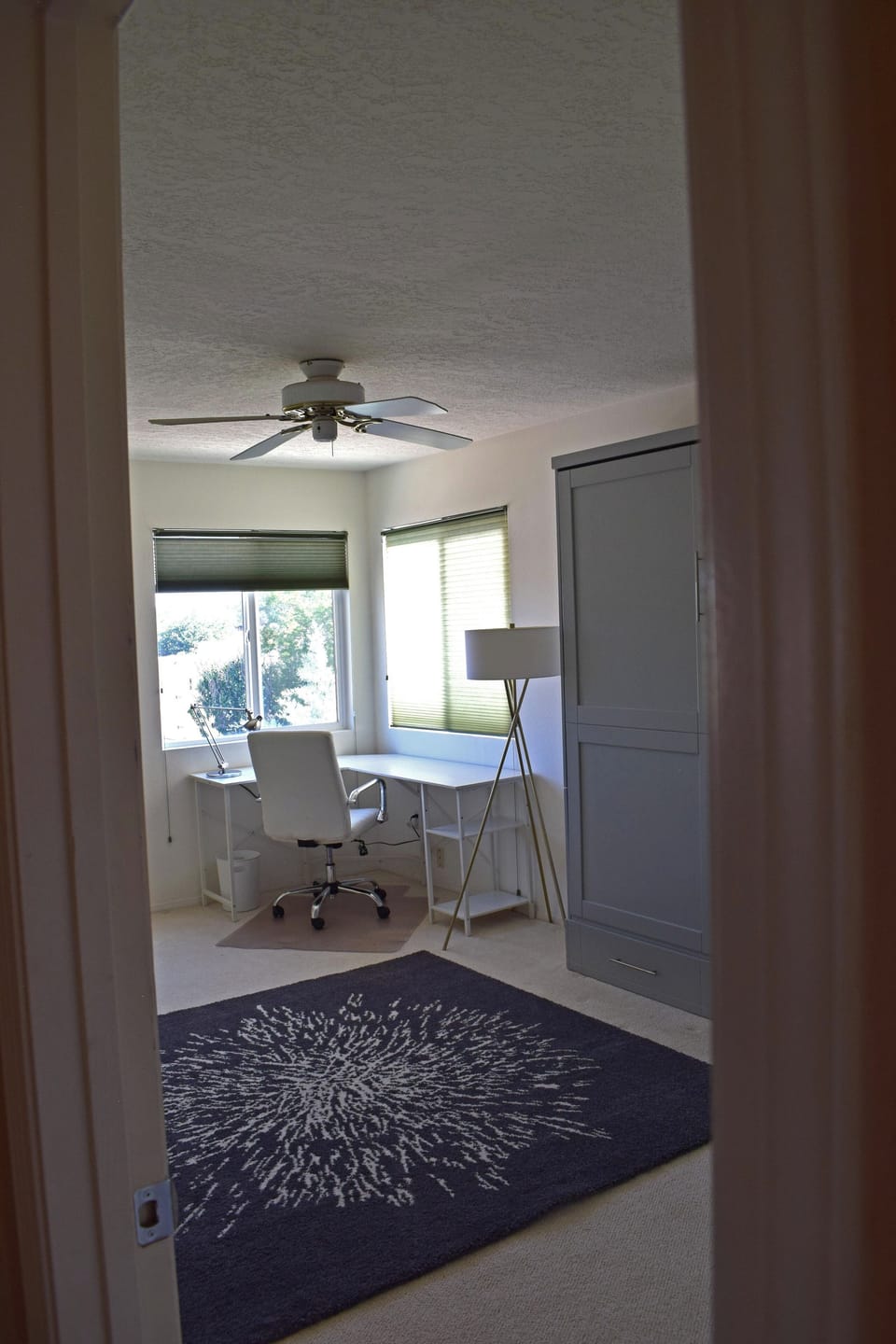 Office with desk looking at mountains and queen murphy bed.