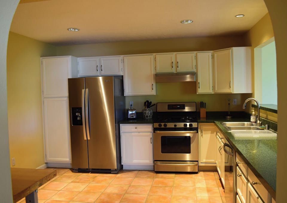 Kitchen with full size refrigerator, gas stove, oven, dishwasher, microwave