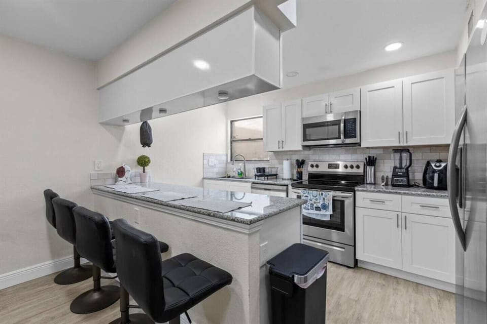 Brand new kitchen with all cooking essentials, and 4 bar stools.