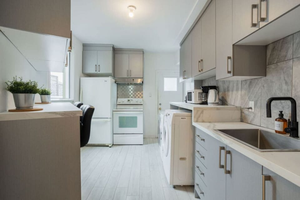 This sleek, fully-equipped kitchen combines style and convenience with modern appliances, ample counter space, and elegant cabinetry—perfect for whipping up home-cooked meals.