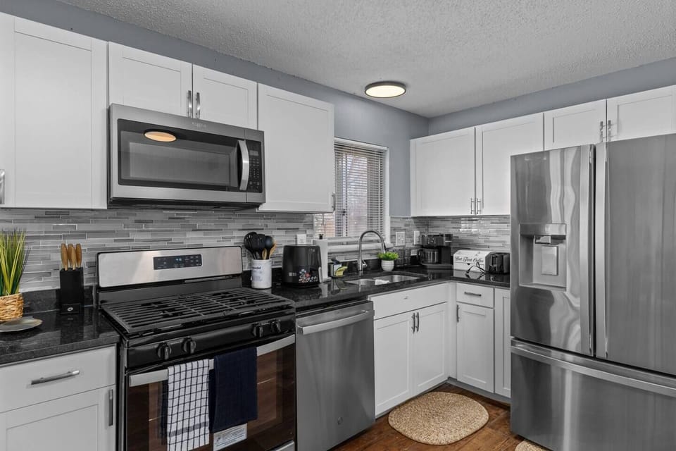 Fully stocked kitchen with stainless steel appliances and modern finishes