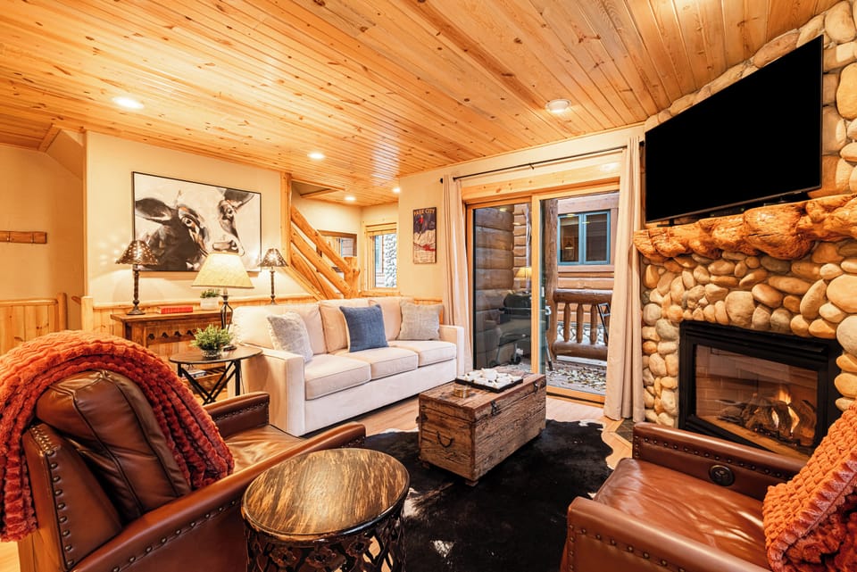 Main Living Space with Queen Sofa Sleeper, Gas Fireplace, TV, & Patio Access