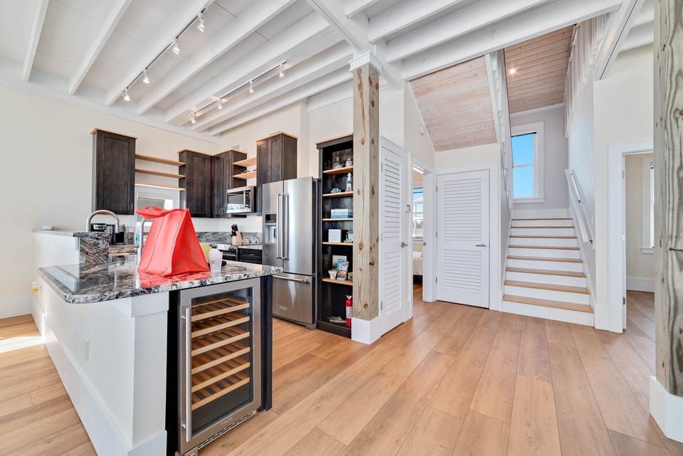 Kitchen with stainless steel appliances including a wine cooler