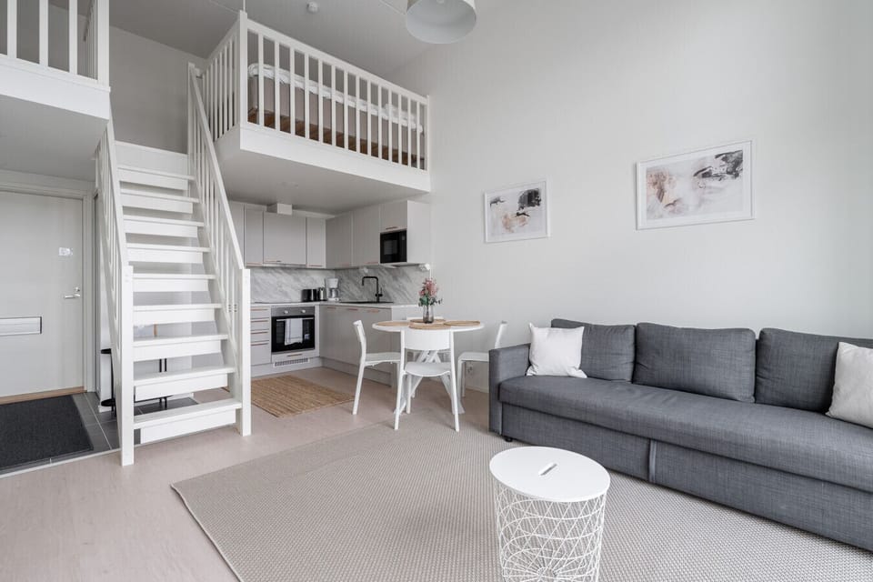 A spacious living room with an open-plan layout and an impressive 4-meter high ceiling.