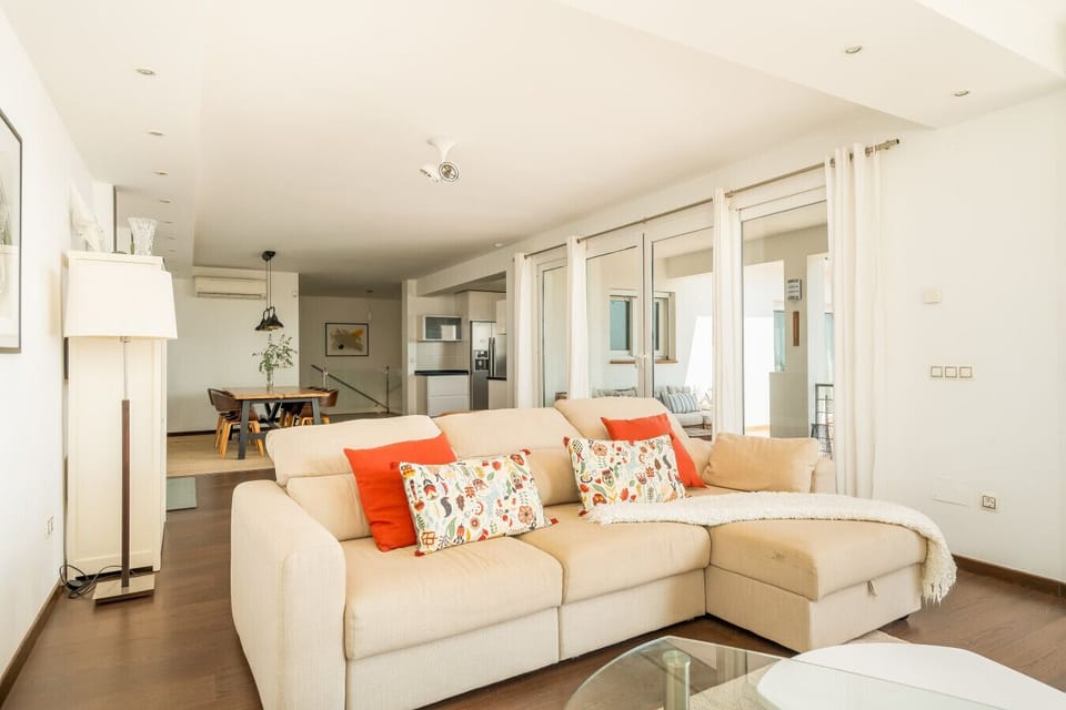 Relax and unwind in the comfortable living room, offering plenty of space for everyone to gather. Large windows fill the room with natural light, creating a bright and inviting ambiance.